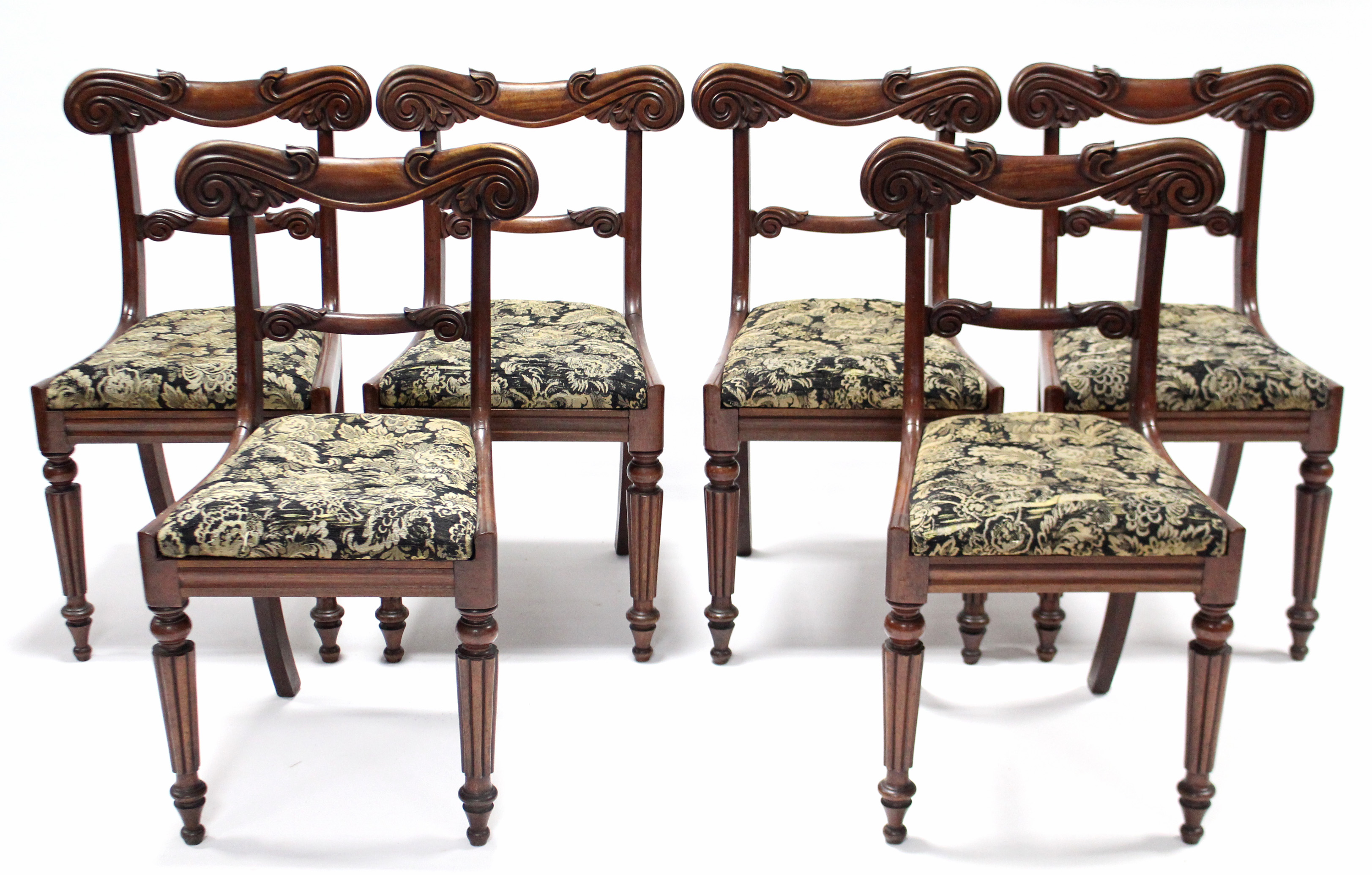 A set of six William IV mahogany bow-back dining chairs with scroll-carved top & centre rails,