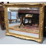 A 19th century carved giltwood picture frame with pierced foliate scroll border, inset later