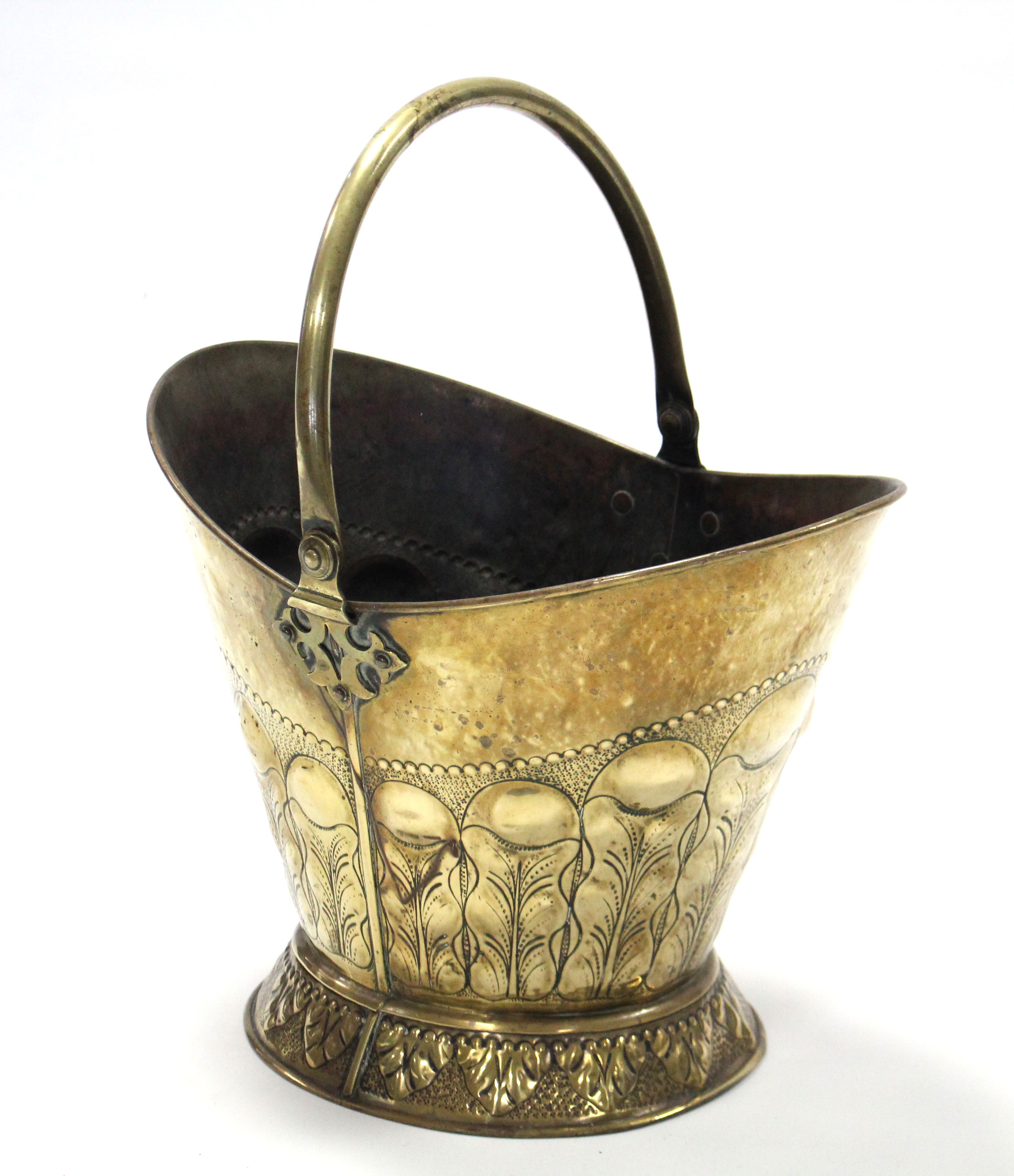 A 19th century brass coal scuttle with embossed foliate decoration, the swing handle with pierced