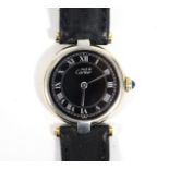 A Must de Cartier ladies’ wristwatch in silver-gilt case, the black circular dial with silver