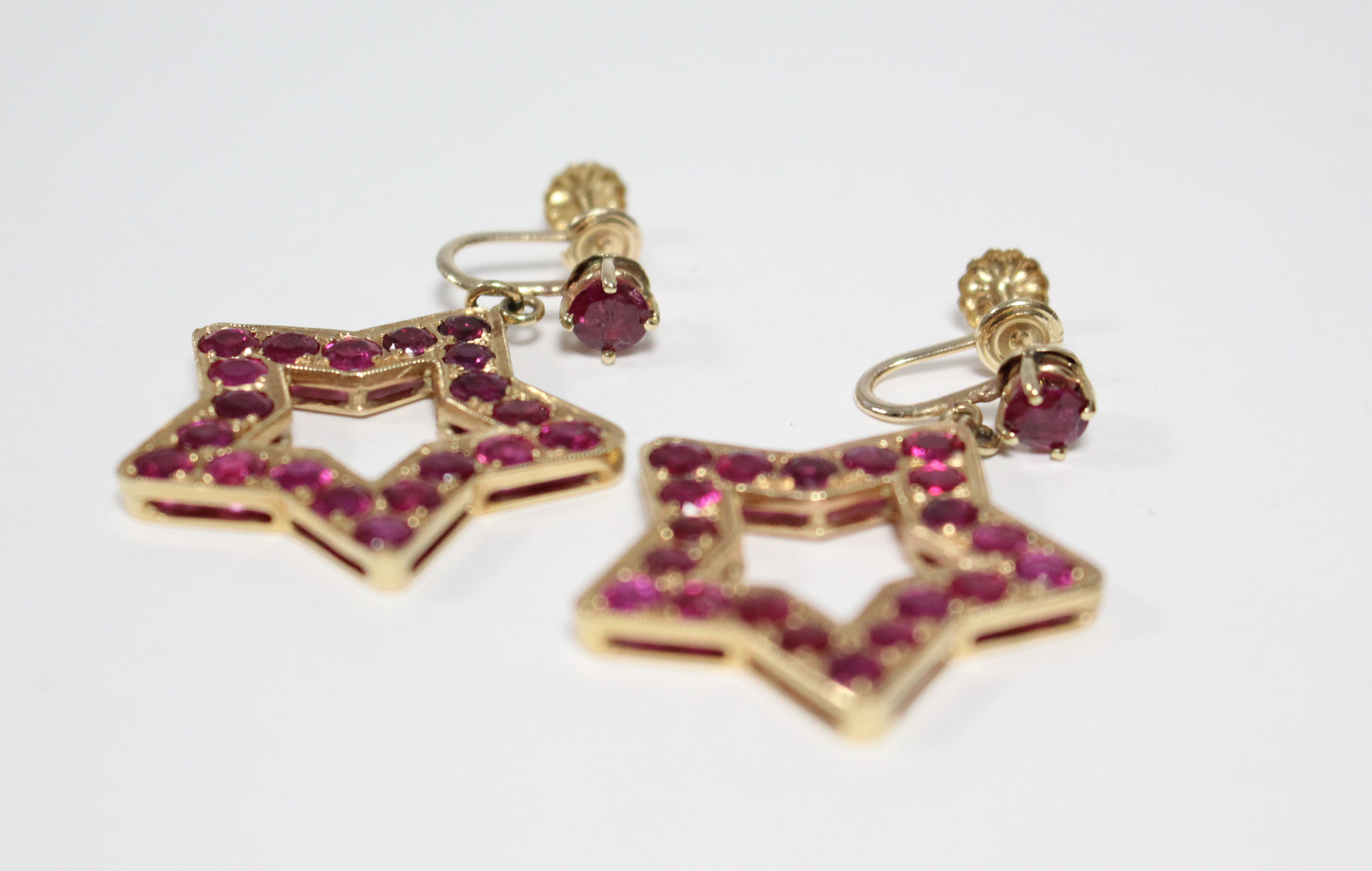A PAIR OF RUBY PENDANT EARRINGS, each of open five-pointed star shape, set twenty round-cut stones - Image 3 of 6