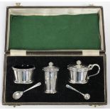 A modern silver three-piece condiment set, each of round tapered form with raised border of Celtic