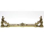 A Louis XV style gilt brass adjustable fender, with rococo style leaf-scroll chenets & pierced