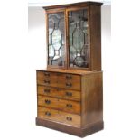 An early 19th century mahogany & satinwood secretaire bookcase with moulded cornice, fitted three