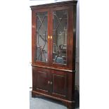 A late 18th century mahogany tall standing corner display cabinet with moulded cornice, fitted three