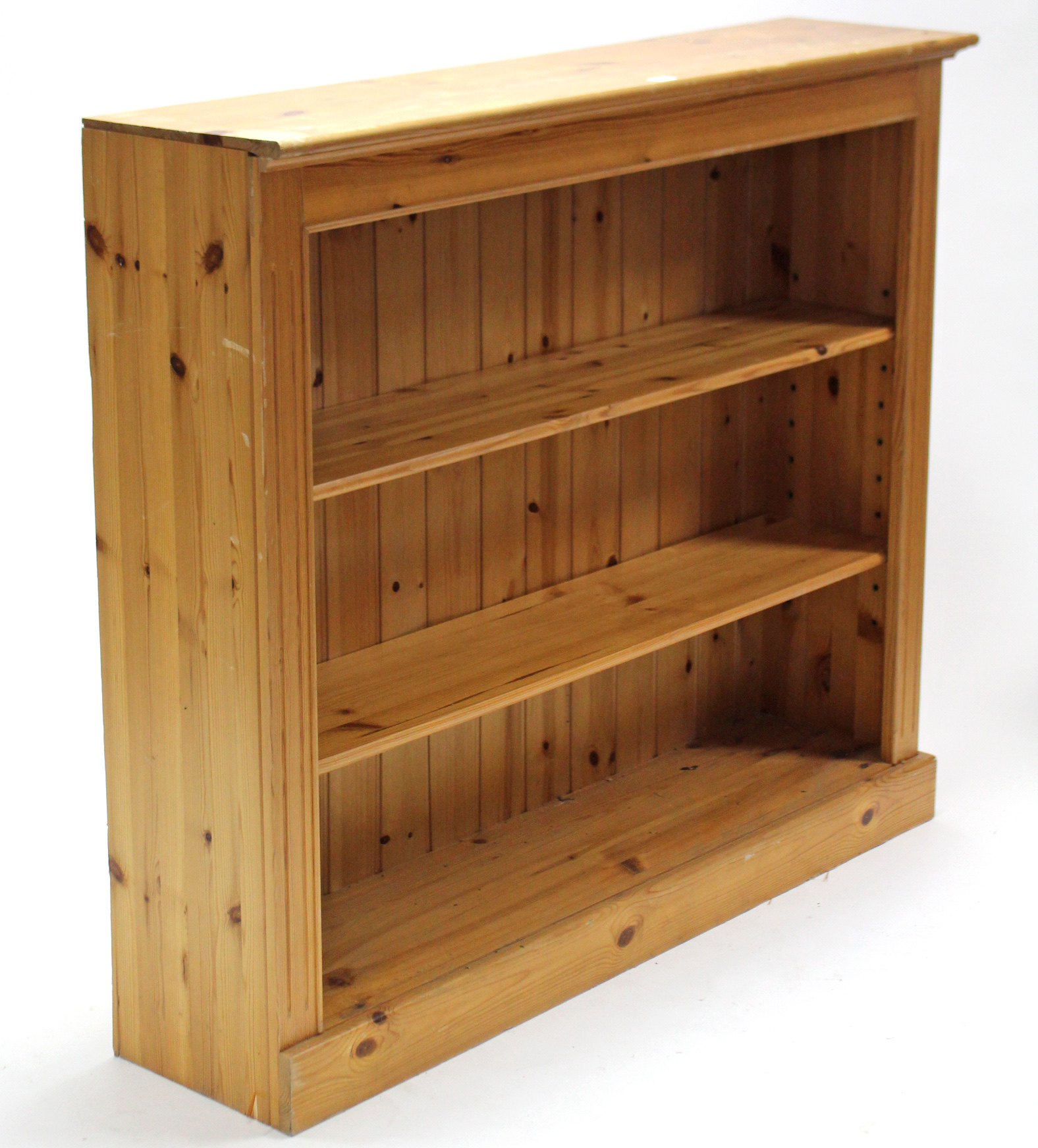 A pine standing open bookcase with two adjustable shelves, & on plinth base, 48½” wide x 42” high.