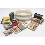 A white glazed ceramic oval baby’s bath; various puzzles & card games; volumes on motor-cars etc.