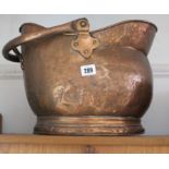 A copper helmet-shaped coal scuttle, 10¾” high; together with a Silverette portable typewriter;