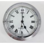 An early 20th century ship’s wall clock, the white enamel dial signed “Smiths English Clock Co.