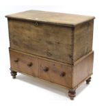 A pine mule chest with hinged lift-lid above two short drawers, & on turned feet, 45½” wide x 40”