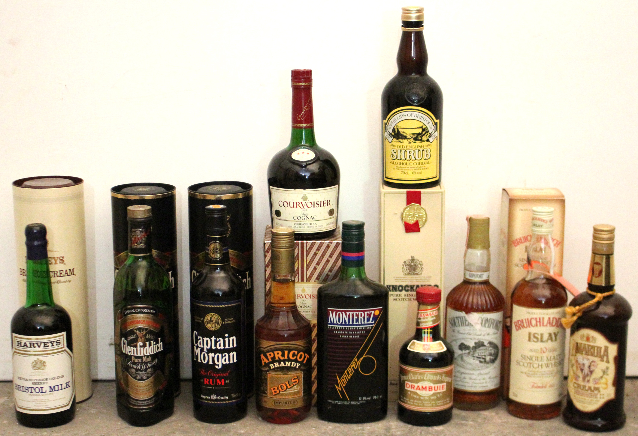 Twelve various bottles of spirits, each with contents.