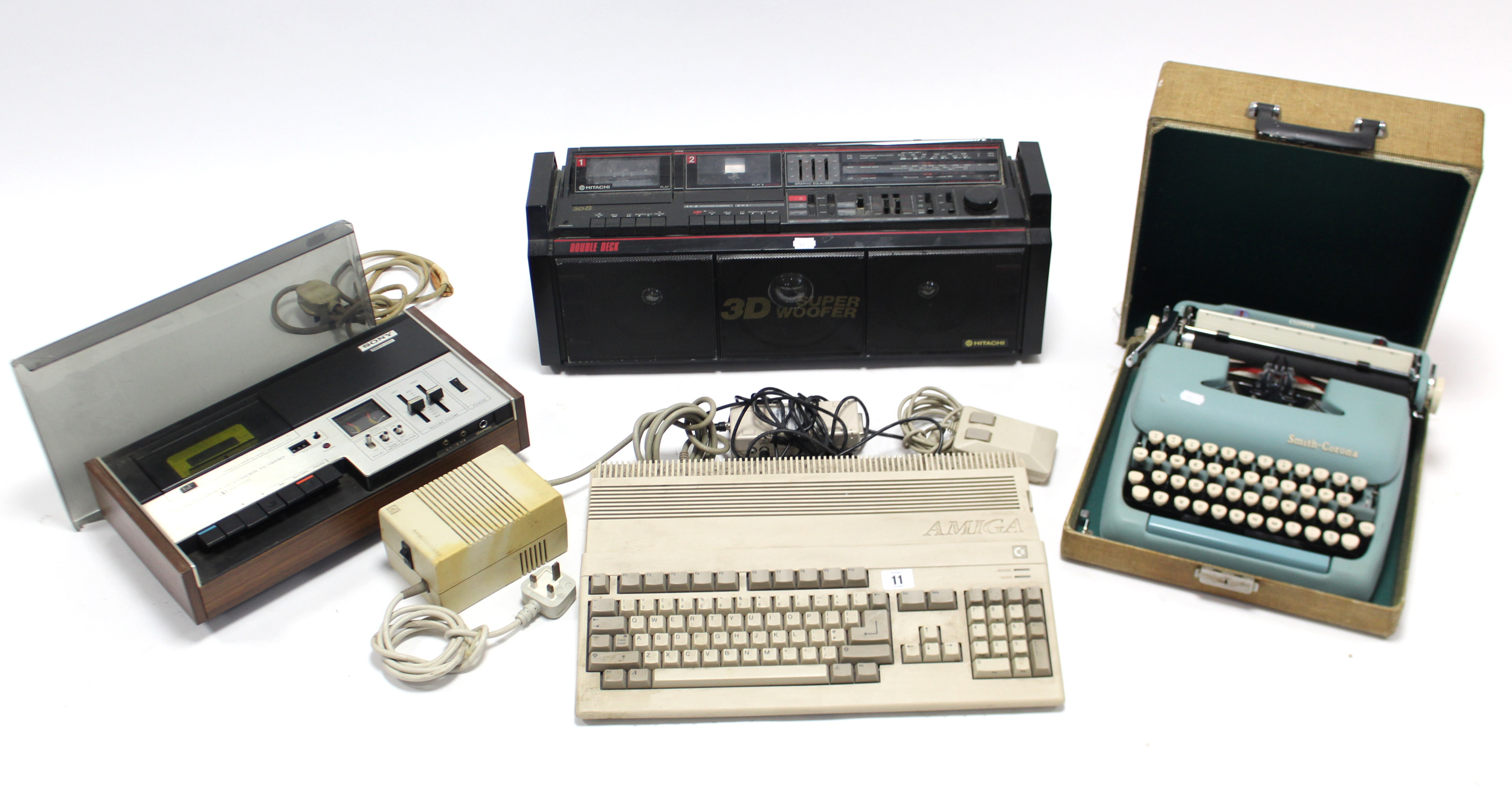 A Commodore “Amiga” keyboard; a Sony stereo cassette recorder; an Hitachi portable stereo cassette