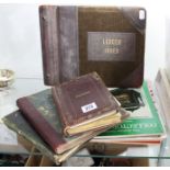 Three late 19th/early 20th century leather-bound scrap books containing various paintings,