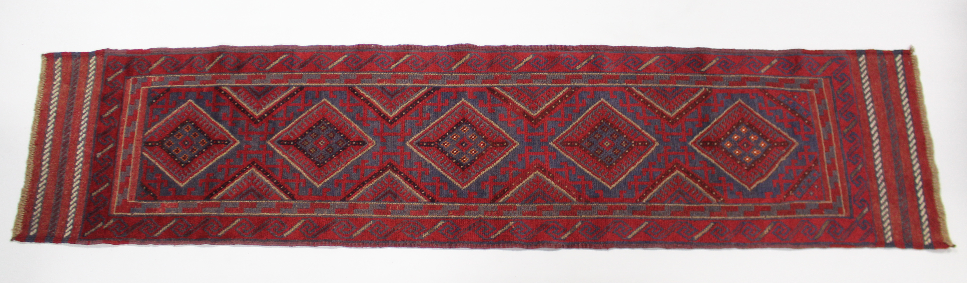 A Meshwari runner of deep blue, red & ivory ground with central row of five lozenges within multiple