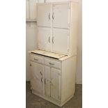 A mid-20th century white painted wooden tall kitchen cabinet, fitted with an arrangement of numerous
