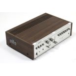 A Sony TA-1066 Solid State Integrated Stereo Amplifier, in teak-finish case, 16¼” wide.