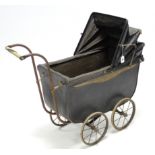 A Victorian coach-built pram (black) with 9” diam. spoke wheels, 28” long; together with an oil