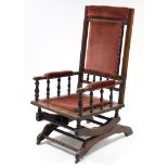 A late 19th century American rocking chair with padded seat, back, & arms upholstered pink velour, &