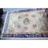 A modern Chinese carpet of cream & deep blue ground, & with all-over multi-coloured floral design,