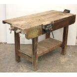 A wooden work bench fitted three clamps, & on square legs, 54” long.