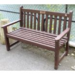 A brown painted teak slatted garden bench, 54½” long.