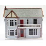 A painted wooden two-storey doll’s house with opening front, 31¾” wide x 18” deep x 24” high;