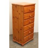 A pine upright chest fitted six long drawers with turned knob handles & on bun feet, 22½” wide x 47”