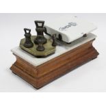 A late 19th/early 20th century shop’s counter-top scale, with white marble slab to the oak