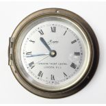 A miniature ships timepiece the silvered dial signed “London Yacht centre, London E.C.2.”, & in