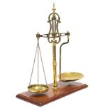 An early 20th-century brass counter-top beam scale by Parnall & Sons, Bristol, stamped "Repaired by