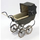 An early/mid-20th century coach-built pram (green), bears label “The Bath Pram Shop, 22/23 Southgate