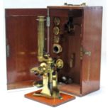 An early/mid-20th century Philip Braham’s of Bath brass monocular microscope, in fitted mahogany