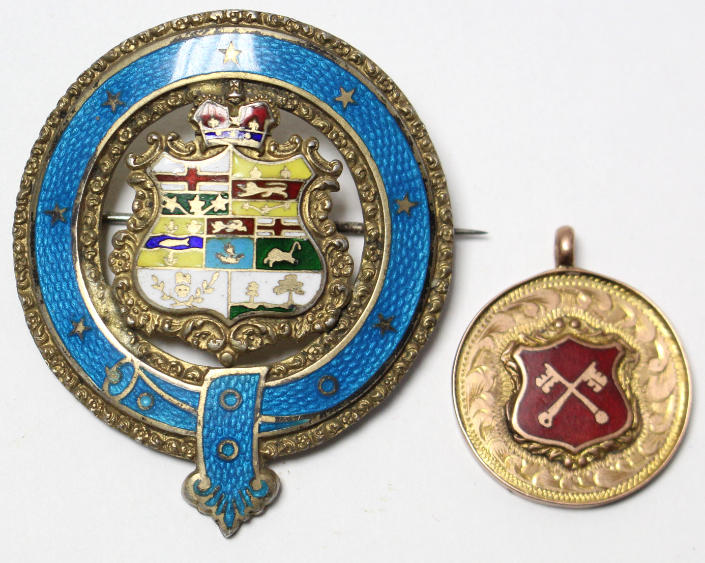 A 1920’s 9ct gold enamelled model awarded to “P.C.L. J. COULSON DIV 2, 1928”; & a sterling silver