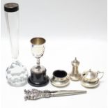 A set of three silver condiments (hallmarks rubbed); a silver trophy cup; a cut-glass spill vase