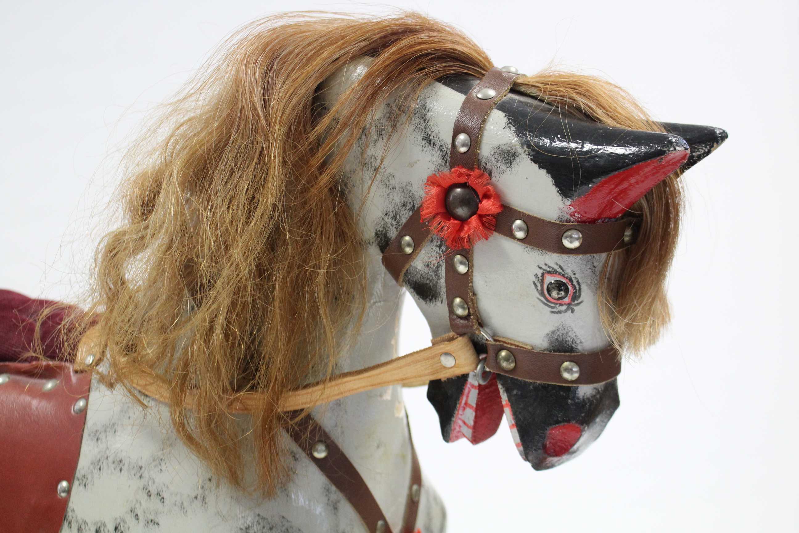 A late 20th century dapple grey painted wooden rocking horse on trestle base, 38” long; & a cloth- - Image 2 of 4