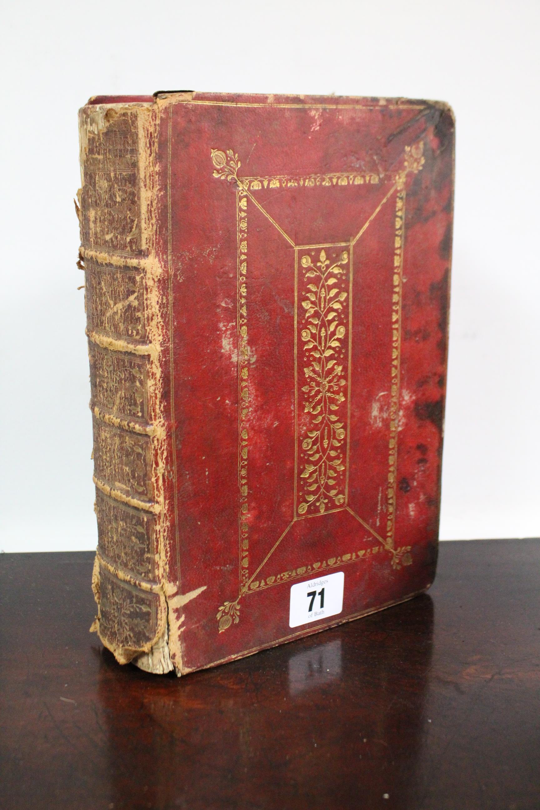 An 18th century Common Prayer Book in gilt-tooled crimson leather binding.