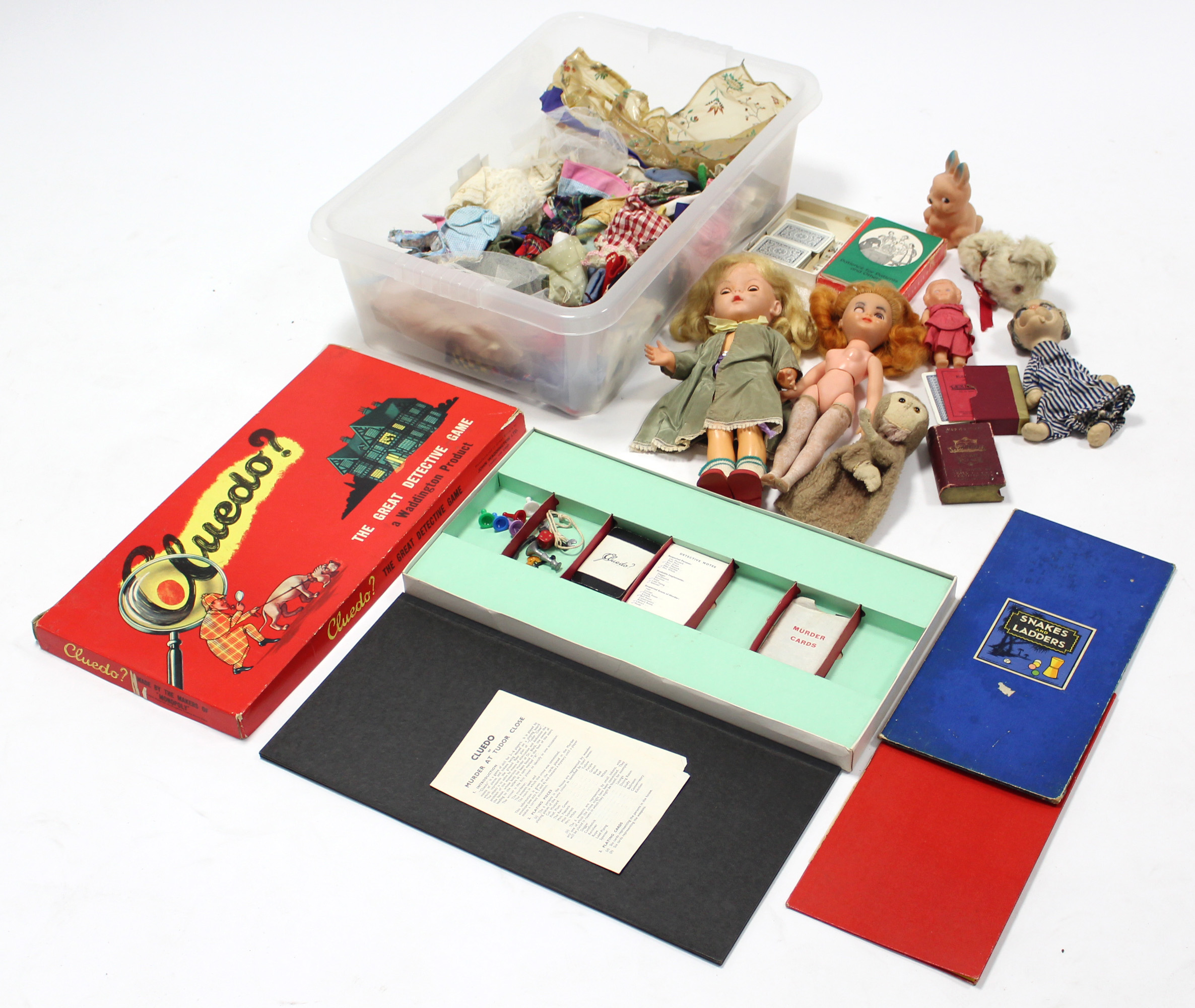 Two celluloid girl dolls; various items of doll’s clothing; a Waddington’s “Cluedo” board game,