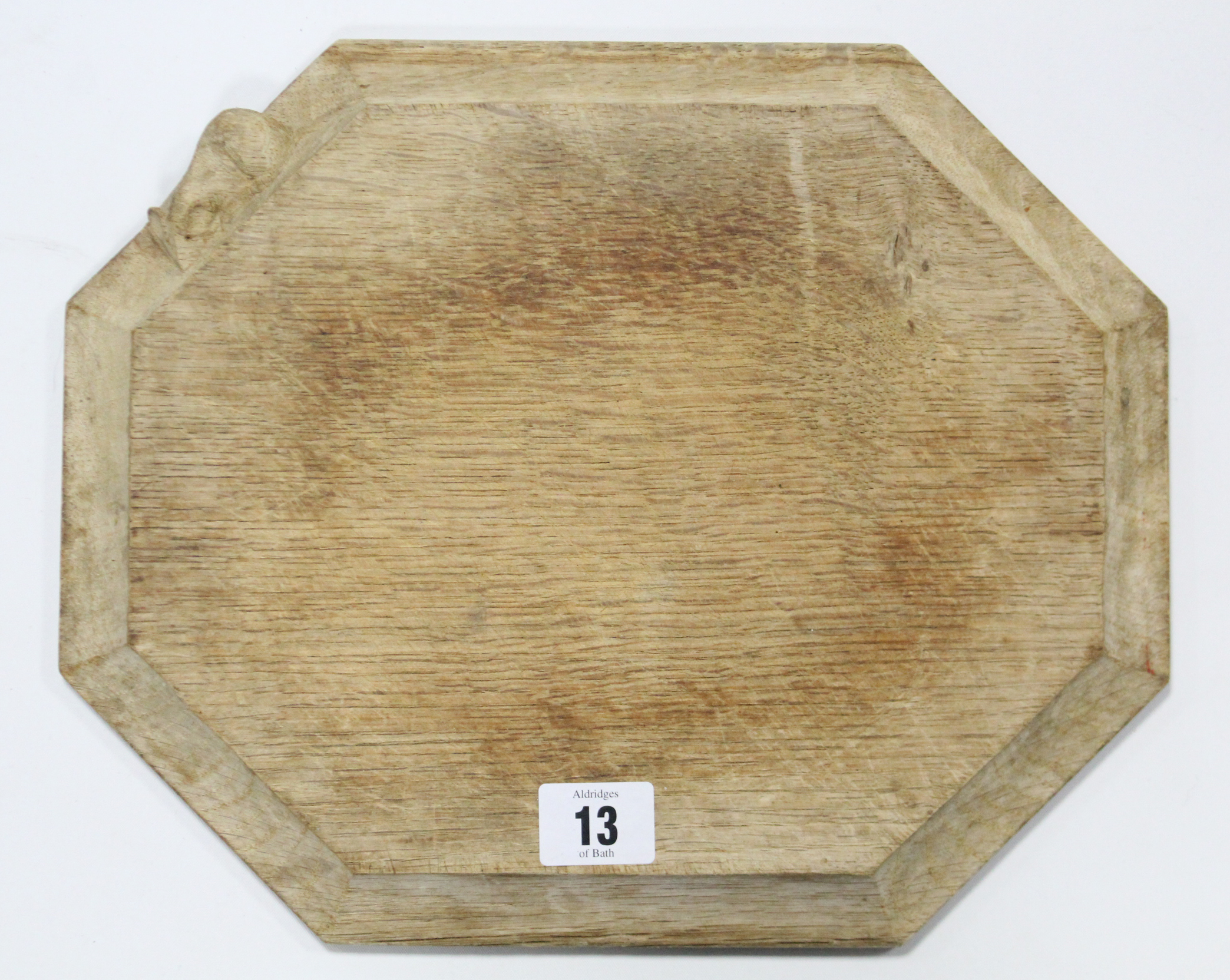 A “Mouseman” light oak bread board of rectangular form & with canted sides, 12” x 9¾”.