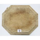 A “Mouseman” light oak bread board of rectangular form & with canted sides, 12” x 9¾”.