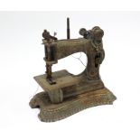 An early/mid-20th century child’s cast-iron sewing machine, 4¼” wide x 5¼” high.