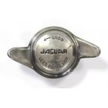 A “Jaguar” wheel hub screw-on cap converted to a paperweight.