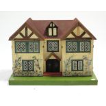 A mid-20th century painted wooden “Cottage” two-storey dolls house with opening front, 23½” wide x