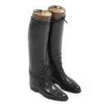 A pair of black leather ladies riding boots with wooden trees each bearing nameplate “MAXWELL