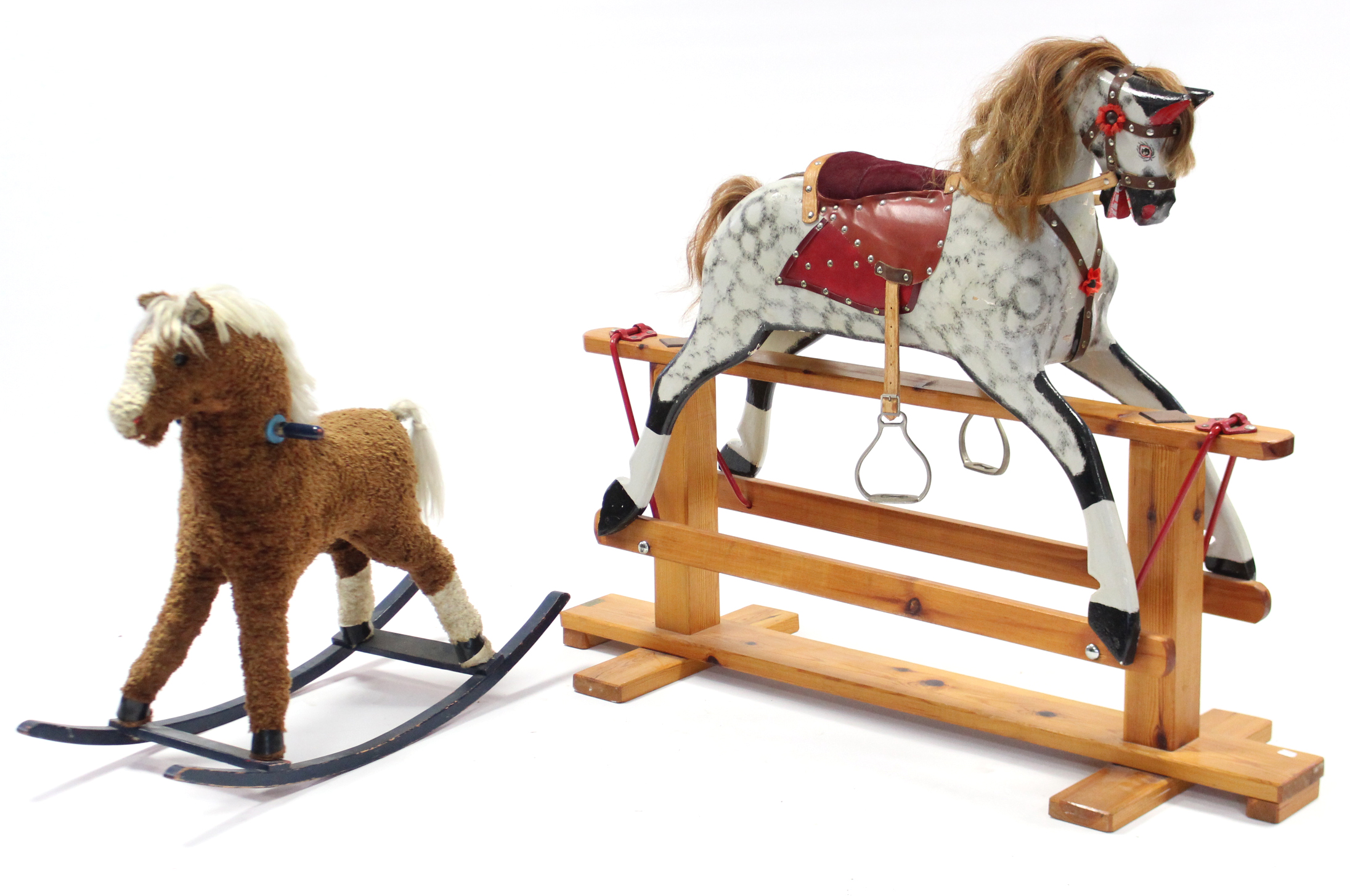 A late 20th century dapple grey painted wooden rocking horse on trestle base, 38” long; & a cloth-