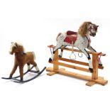 A late 20th century dapple grey painted wooden rocking horse on trestle base, 38” long; & a cloth-