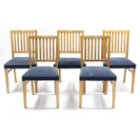 A set of five maple-finish rail-back dining chairs with padded seats, & on square tapered legs.