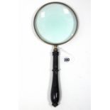 A modern 6” diam. magnifying glass with simulated treen handle, 14½” long.