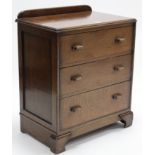 A mid-20th century small oak chest, fitted three long graduated drawers with block handles & on