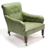 A late Victorian buttoned green leatherette armchair on short turned legs with shepherd’s castors.