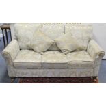 A modern three-seater settee with square back & scroll arms, upholstered gold & ivory floral